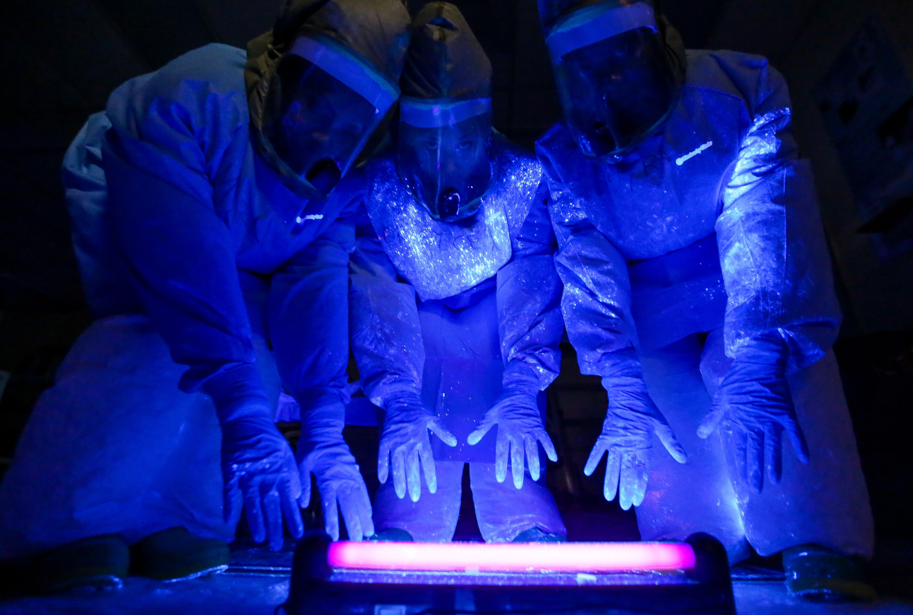 A black fluorescent light shows where simulated bodily fluid containing a mock Ebola virus landed on a care team's personal protective equipment, during a training exercise at Madigan Army Medical Center's Andersen Simulation Center, Nov. 6, 2014 A black fluorescent light shows where simulated bodily fluid containing a mock Ebola virus landed on a care team's personal protective equipment, during a training exercise at Madigan Army Medical Center's Andersen Simulation Center, Nov. 6, 2014